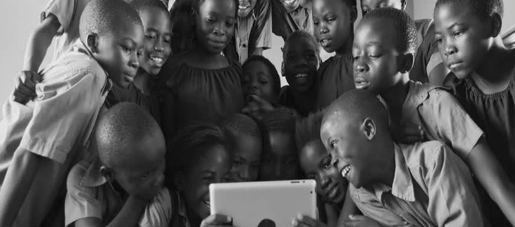 A picture of children looking at the tablet